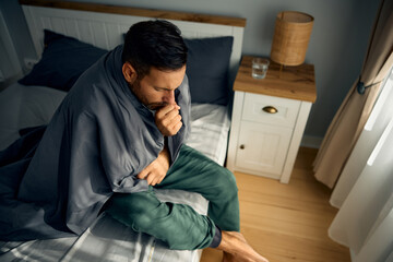 Above view of sick man coughing.