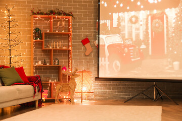 Interior of living room with Christmas lights, sofa and projector screen