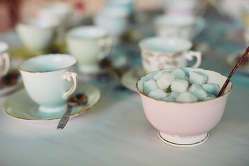 Tea party, cups and table for lunch, brunch or breakfast at gathering, event or special occasion. Catering, background and wallpaper for celebration, picnic and drinking as texture in house or lounge