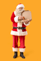 Santa Claus tasty pizza on yellow background