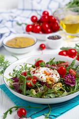 Salad with poached egg.