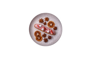 Sweet eclair or profiterole with strawberry custard