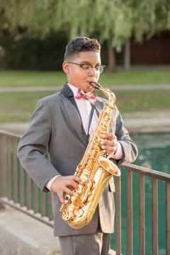 Boy playing the saxophone outside