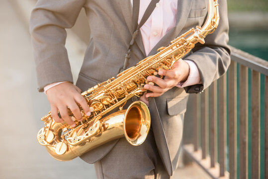 Close up of a young boy playing the saxophone