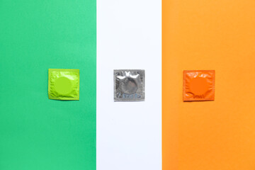 Set of condoms on color background