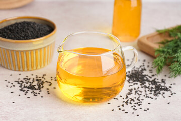 Jug of oil with sesame seeds on white background