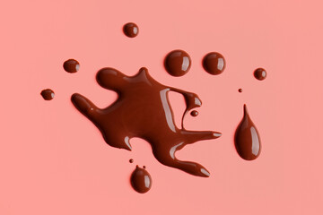 Sweet chocolate splashes on red background