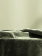 Green velvet fabric cloth throw blanket on podium table in sunlight on wall for luxury, elegant...