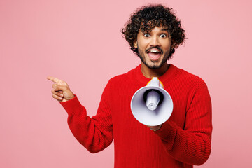 Young Indian man he wear red sweater casual clothes hold in hand megaphone scream announces...
