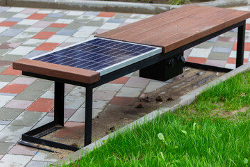 A bench seat with a solar panel. Use of solar panels in yards near houses