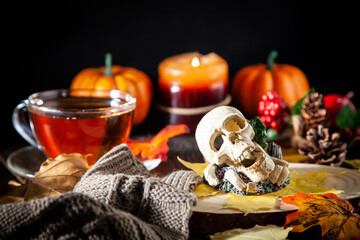 Autumn Decor with Scarves, Pumpkins, Candles, and Yellow Leaves
