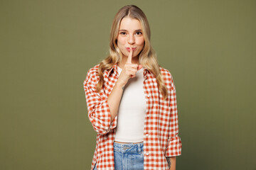 Young woman she wear red shirt white t-shirt casual clothes say hush be quiet with finger on lips...