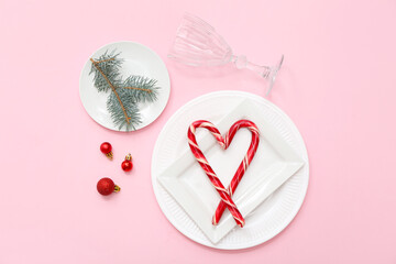 Beautiful table setting and Christmas decoration on pink background