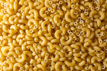Uncooked Chifferi Rigati Pasta: A Culinary Canvas of Chifferi Rigati, Creating a Lively and Textured Background for Gourmet Cooking. Dry Pasta. Raw Macaroni - Top View, Flat Lay