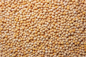 Uncooked Yellow Polished Peas Background. A Culinary Canvas of Dry Yellow Peas, Creating a Lively and Textured Background for Gourmet Cooking. Scattered Raw Polished Peas. Healthy Eating Ingredients