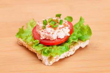 Rice Cake Sandwich with Tomato, Lettuce, Fish Cream and Green Onions on Bamboo Cutting Board. Easy Breakfast. Quick and Healthy Sandwiches. Crispbread with Tasty Filling. Healthy Dietary Snack
