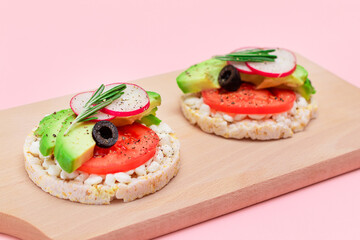 Rice Cake Sandwiches with Avocado, Tomato, Cottage Cheese, Olives and Radish on Wooden Cutting Board. Easy Breakfast. Diet Food. Quick and Healthy Sandwiches. Crispbread with Tasty Filling