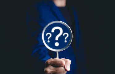 Question mark, Problem solving and analysis concept. Businessman holds magnifying glass focused on question mark, analysis, problem solving, identifying cause of issues during work process, solution,