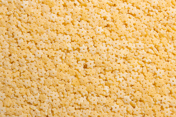 Uncooked Stelline Pasta: A Culinary Canvas of Stelline Macaroni, Creating a Lively and Textured Background for Gourmet Cooking. Dry Pasta. Raw Macaroni - Top View, Flat Lay