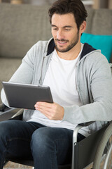 disabled business man in wheelchair using tablet pc