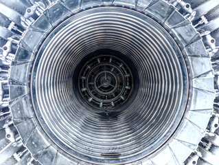 Close up of a large jet or airplane engine turbine. Back of an old airplane. Blue toned