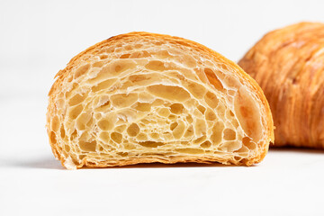 Cut in Half Croissant with Inside Texture and Thin Crisp Layers. Delicious French Pastry. Light background.