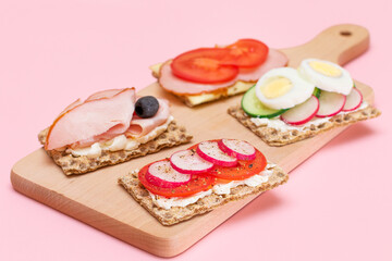 Different Whole Grain Crispbread with Ham, Tomato, Radish, Cucumber and Cheese. Easy Breakfast. Diet Food. Quick and Healthy Sandwiches. Crispbread with Tasty Filling. Healthy Dietary Snack