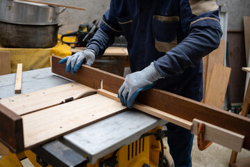Detail of Mexican carpenter cutting wood with electric saw