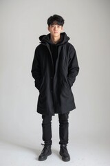 Full length portrait of young man standing on white background