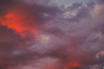 dramatic and colorful sunset clouds in summer time