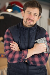 male artisan holding a staple gun