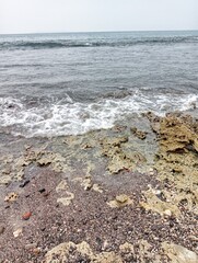 Waves crashing against the rocks on the shore