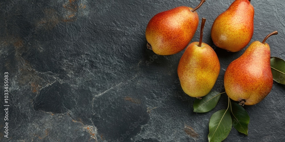Aufkleber Fresh pears on a black stone surface. Fruits. Free space for text. Top view.