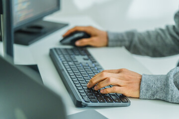 close up  developer hand coding with keyboard on desk  at modern office