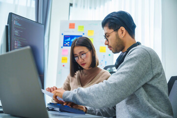 asian and Indian Developer team discussion feedback analysis coding data with software computer at...