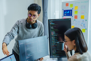 asian and Indian Developer team discussion feedback analysis coding data with software computer at...
