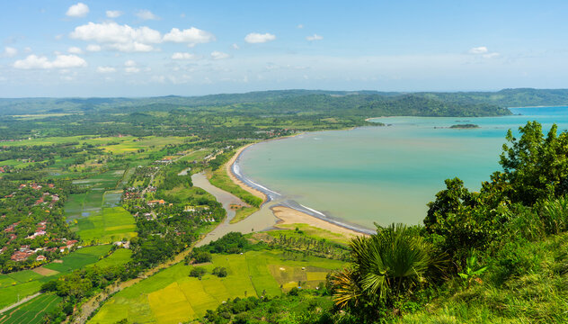 View from above, expanse of rice fields, beach, and rural atmosphere in the Ciletuh Geopark area, Sukabumi, West Java, Indonesia. The Ciletuh area has been designated as a UNESCO Global Geopark.