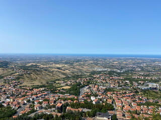 An amazing natural picture surrounds the hill on which San Marino is located against the background of the distant sea strip on the horizon.