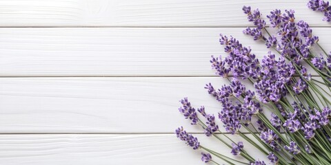 Obraz premium lavender flowers on a white wooden table background, top view