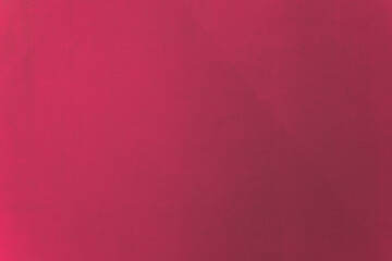 Raspberry pink color similar to evening primrose paint on cement wall texture as background.