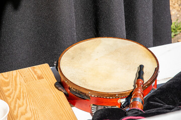 a tambourine and a bagpipe on a table at a folkloric event in Galicia, Spain