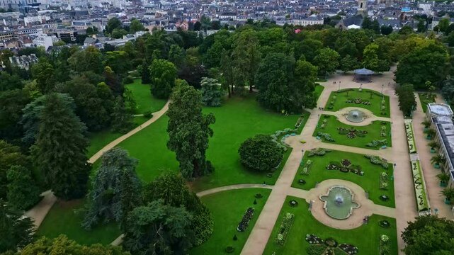 Thabor gardens with fountains and flower beds, Rennes in France. Aerial drone flyback panoramic view