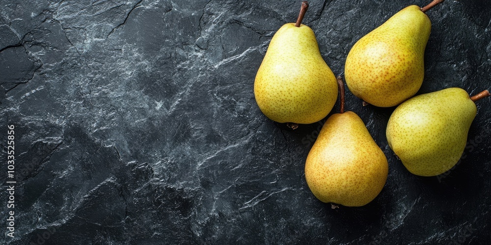Poster fresh pears on a black stone surface. fruits. free space for text. top view.