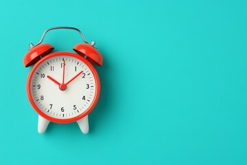 A classic red alarm clock with a white dial on a blue background, symbolizing time, punctuality, and the importance of planning.