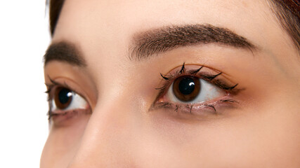 Close-up shot of a woman eyes, focusing on her lashes and brows, emphasizing natural beauty. Lash...
