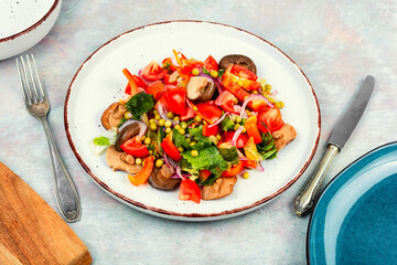 Vegetable salad with pickled mushrooms.