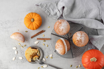 Fresh baked pumpkin cinnamon muffin icing sugar powder top view as autumn seasonal dessert.