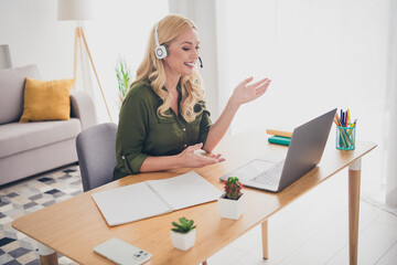 Photo of charming adorable woman operator consultant sit table workplace work from home support...