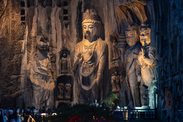 Luoyang, China: The famous Buddha statues at night in the Luoyang Longmen Grottoes in China. The statues dates from the 7th century and the Tang dynasty in Henan province