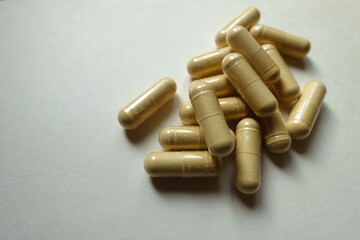Fistful of beige capsules of Saccharomyces boulardii probiotic dietary supplement